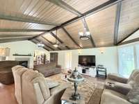 Wood Plank with wood beams in the vaulted ceiling in Living Room