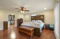 16x15 Primary Suite with hardwood flooring  with ample natural light; Large walk in 11x10 closet AND 11x10 Workout Room; Primary Bath is tile flooring