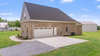Garage with concrete parking pad