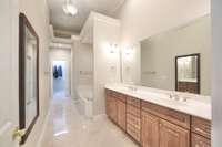 Master Bath features marble floors, large bathtub, double vanities and spacious closet