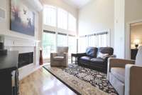 Gorgeous floor to ceiling windows with remote control blinds. Doors open onto screened-in porch leading to open deck