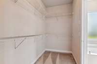 One side of the primary bedrooms walk-in closet