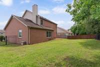 Level backyard with maintenance free wrought iron fence.