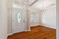 Foyer and formal dining room with double crown molding