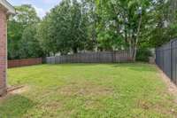 Level backyard with wrought iron fence