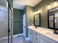 Owners Bath with Spacious Comfort Height His-N-Hers Vanities & Custom Tile Shower....