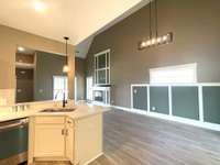 View from Kitchen into Dining Area & Great Room with Volume Ceiling & special trim & paint.....