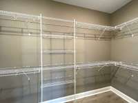 Owners closet load with hanging space & shelving....
