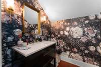 Check out this fun powder room......love the wallpaper!