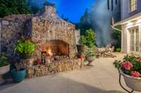 This stone fireplace is really beautiful in its own right....notice the patio French doors in your right that leads to the downstairs primary suite...