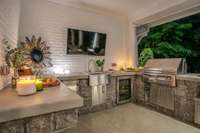 Now is the time to start enjoying your outdoor space...the summer kitchen was installed in 2020 and hosts a beverage fridge, ice maker, sink, grill and Green Egg...all of which remain with the home...