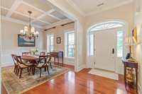 Formal dining with trimmed ceilings, extensive molding and wallpaper making this space elegant and inviting