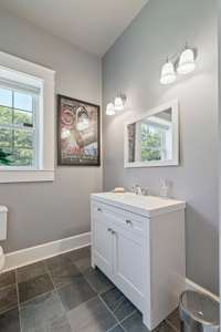 Inside you will find a sitting area separate from the sound proof music studio. This offers a half bath for guests.  If you are not a musician, this could be converted to a kitchenette and the bathroom has a closet that a shower could be added.