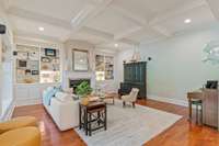 High ceilings coffered with exstensive trim, built in shelves and cabinets and a woodburning fireplace that is also stubbed for gas if you choose to change out the logs.