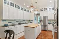 Black Indian honed granite expands throughout the outer counters in this expansive kitchen.