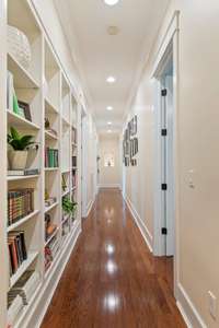 Long hallway leading to the 4 bedrooms lined with built in shelves!