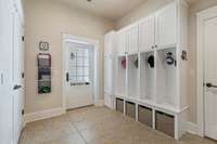 Large mud room, drop zone, and laundry room located coming in from the garage or off of the back door that leads to the music studio/1200 sf extra living space.  The washer and dryer are tucked behind the doors for out of sight laundry days!