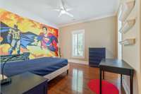 3rd bedroom with a large closet, plantation shutters, and Engineered hardwood flooring. Jack and Jill bath in between 2nd and 3rd bedroom.  (Batman/Superman Canvas does NOT convey with the sale of the home)