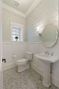 Half bath located just off of the family room and kitchen for guests