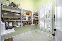 A very large pantry space just off of the kitchen.  Both sides of this room have shelves for all of your food, paper products, or small appliances.
