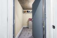 The room we all need but hope to never use...a Storm shelter/safe room! This room was built into the home's concrete pour at construction.  With 9" bolts in a steel door concealed by a regular wooden door within the home. Maybe a wine cellar??