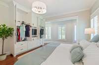 Showing European Gentlemen's Wardrobe with the pull down rack system that allows for upper and lower clothing to hang on both sides.  Drawers as well as cabinets for extra hidden space