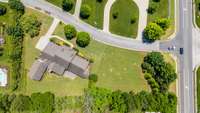 The entire greenspace surrounding the home within the tree line is part of the 1.23 acres