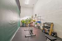 This basement area is currently used as a workout room, has high ceilings and previously had a regulation height basketball goal!