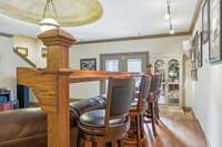 Custom built in bar seating behind sofa area