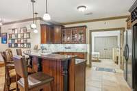 Custom cabinetry, granite countertops and bar seating