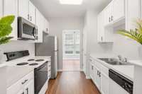 Sleek and stylish modern kitchen design with bold black hardware accents.