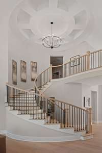 As you approach the staircase, you're immediately captivated by its sophisticated curves and dramatic details, which exude a sense of awe and wonder.