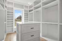 With custom shelving, hanging spaces, and built-in drawers, this closet offers an abundance of storage options, ensuring everything has its place.