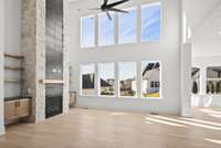 Features like floor-to-ceiling windows invite natural light to fill the space, while high ceilings and open-concept living create an airy, expansive feel.