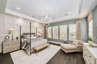This spacious suite features luxurious finishes, a spa-inspired en suite bath, and expansive windows that bathe the room in natural light, creating a serene and inviting atmosphere.