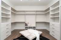 Shelves and drawers galore in the owner's suite closet with their private laundry across the room!