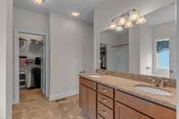 Primary ensuite featuring granite with dual vanities