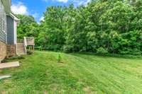 Relax on the rear deck overlooking the wooded area