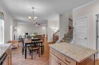 View from kitchen towards living area with laundry area featuring large utility sink on the right