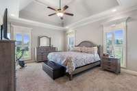 Primary Bedroom Located On Main Level With Deep Trey Ceiling And Recess Lighting