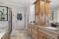 Primary Bathroom With Tile Flooring And Double Granite Vanities