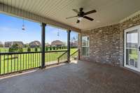 Covered Porch Overlooking Beautifully Landscaped Backyard