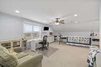 This large room is L-shaped. There's many option for the area where to quilting wheel is. See a couple of options in the next 2 virtually staged pictures.