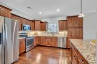 Large kitchen with lots of cabinets and stainless steel appliances.