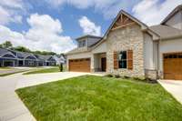 This lovely corner unit has a tasteful combination of brick, stone, and Hardie siding!