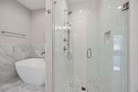 A beautifully tiled shower and freestanding tub make this a spa experience!