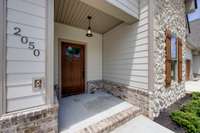 The covered Front Porch allows visitors to stay out of the elements upon arrival!