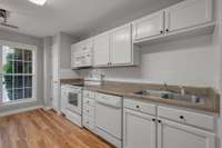 Kitchen.  Featuring the white appliances and lots of storage.
