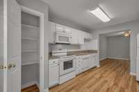 Kitchen.   View of the cabinetry, many of the appliances, and the pantry which is the open door to the left.