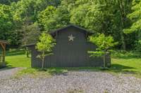Barn accentuates the rustic charm and appeal of the property, while providing small additional storage area.
